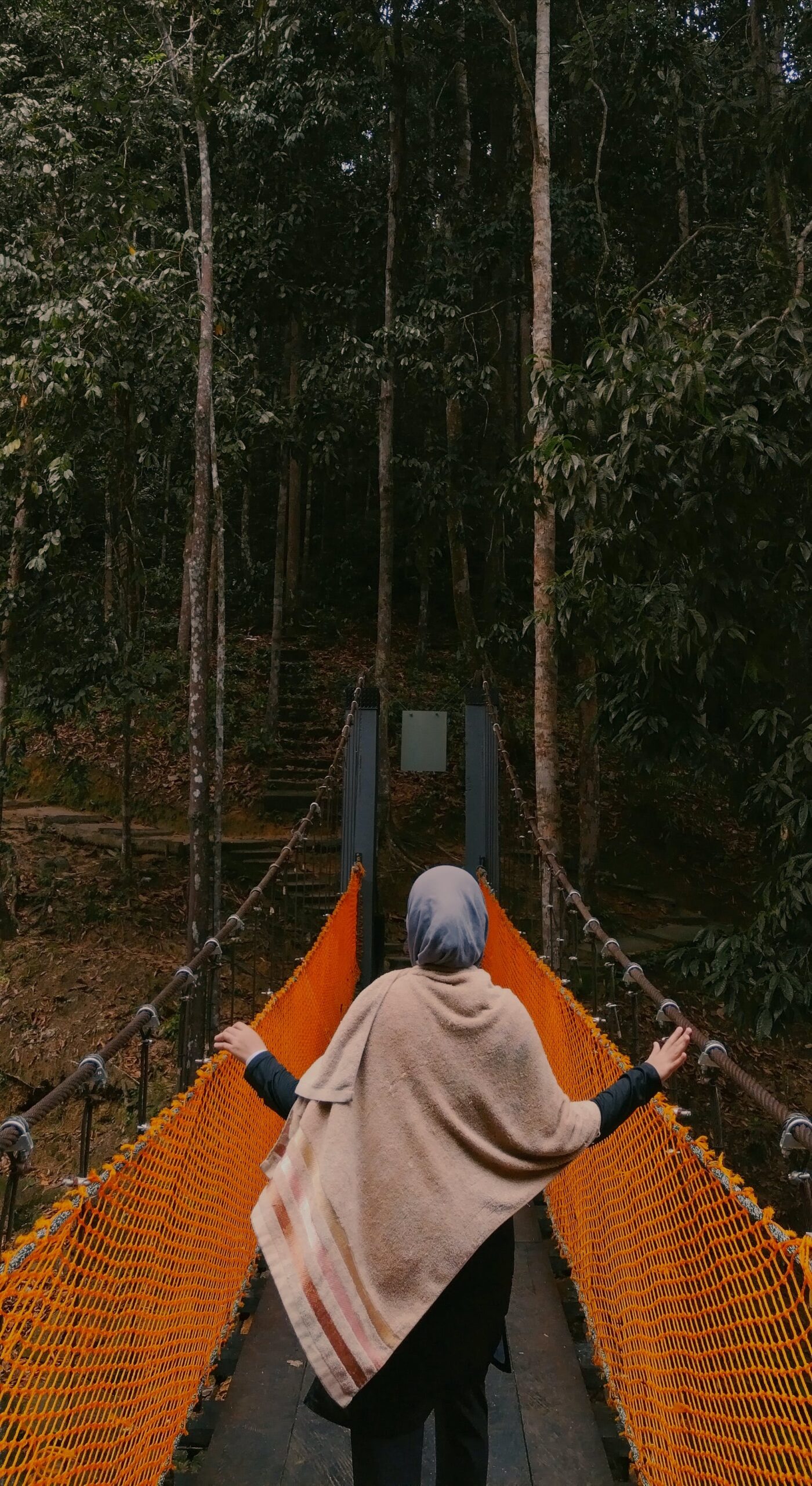 woman-walking-on-a-suspension-footbridge