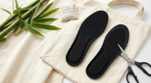 the trimmable RoamingFeet Bamboo Charcoal Insoles resting on natural cotton